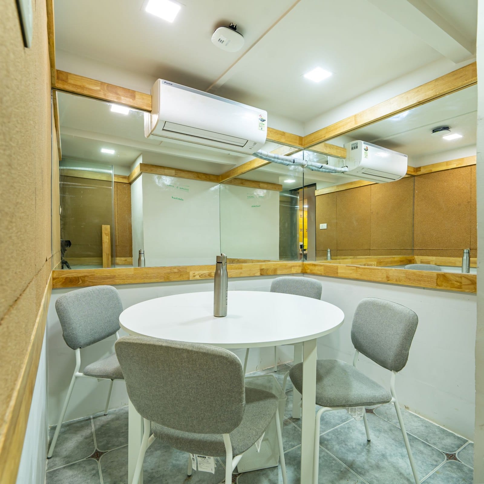A small meeting room with a round table for four