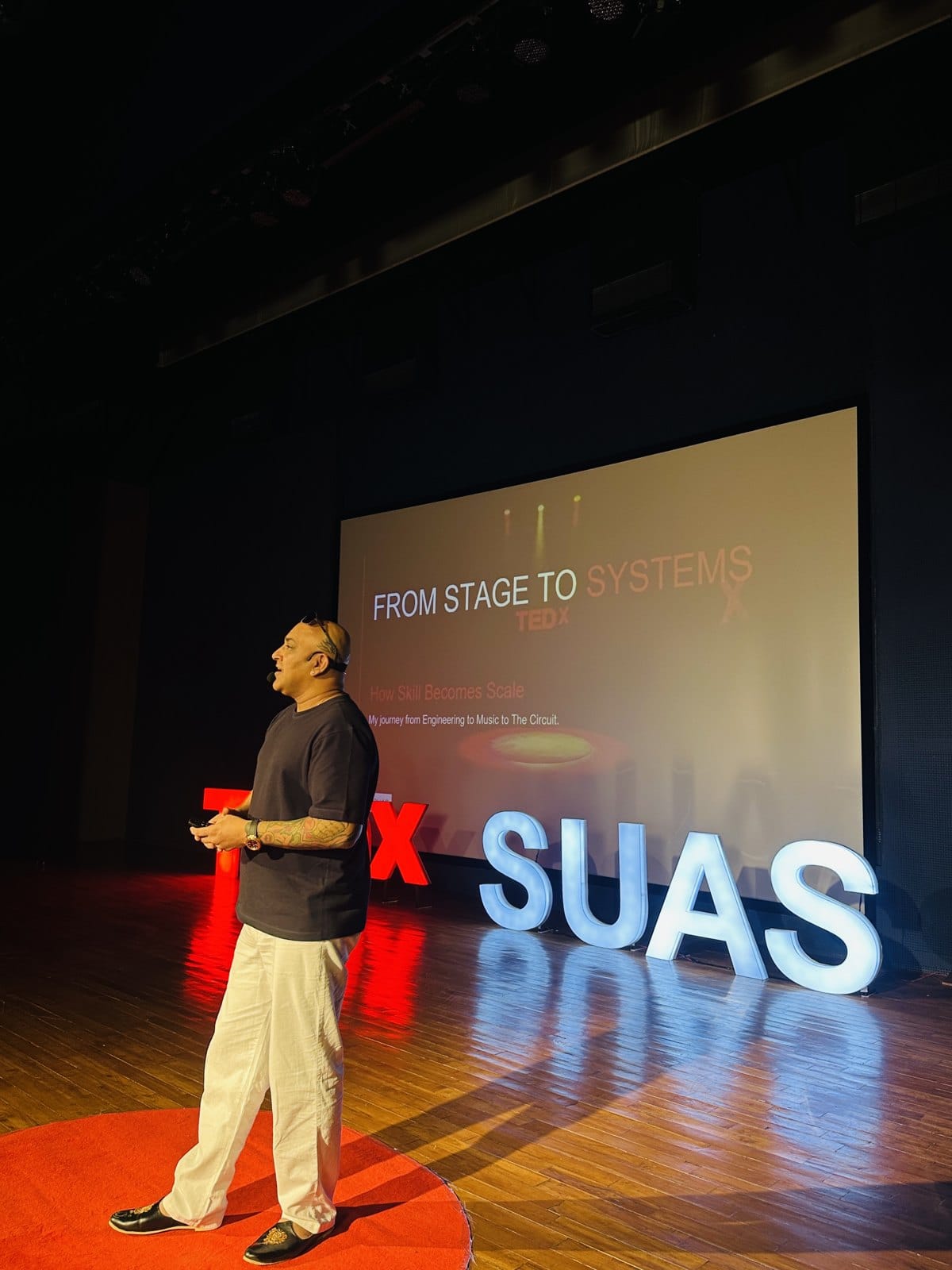 Sherrin Varghese on the TEDxSUAS stage, April 2026